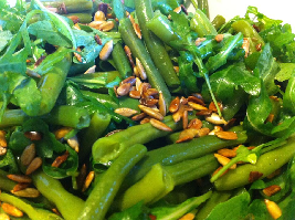 Groene salade van sperziebonen, biologische rucola en geroosterde zonnebloempitten